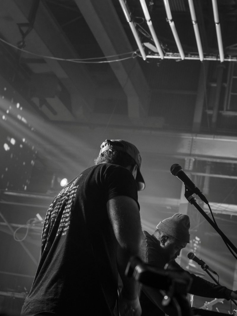 Backstage silhouette against stage lighting and rigging before GZA takes the mic, Charleston concert photography