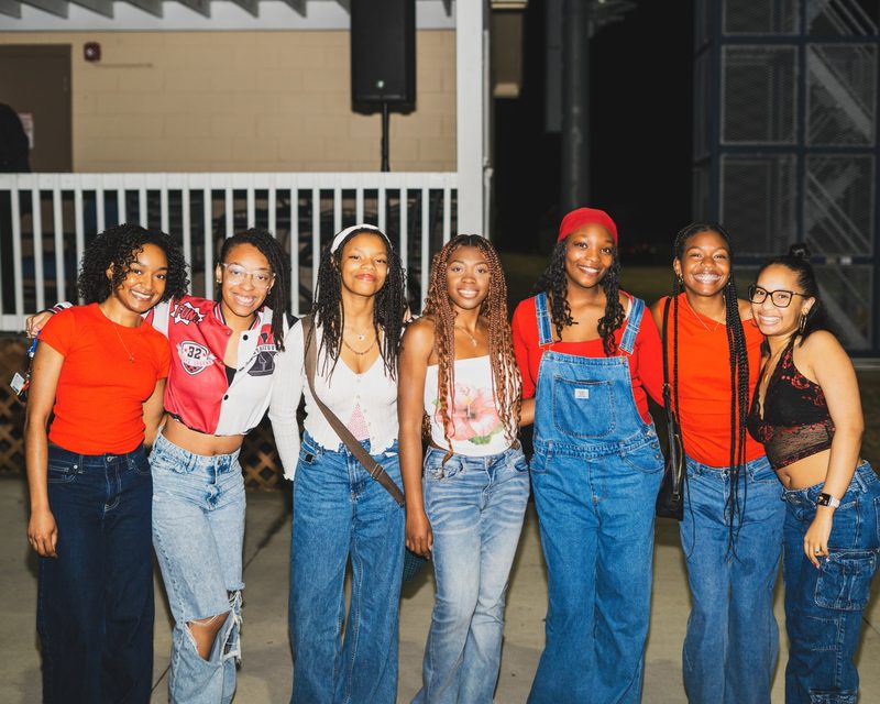 Group of friends smiling together at a college block party