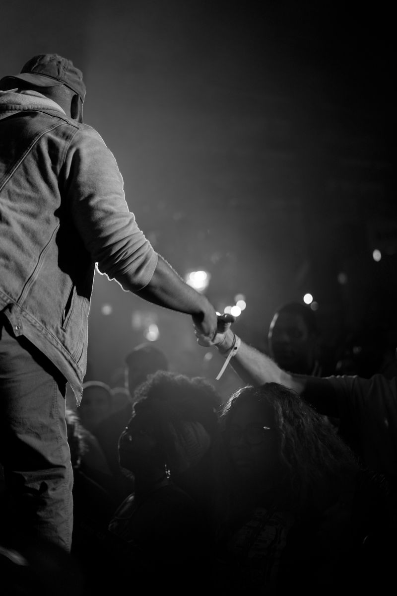 Performer reaching into the crowd to shake hands with fans during GZA's Charleston show