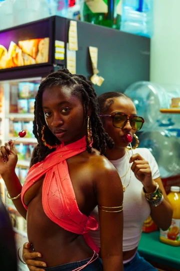 Two models sharing a candid, playful moment during a store photoshoot