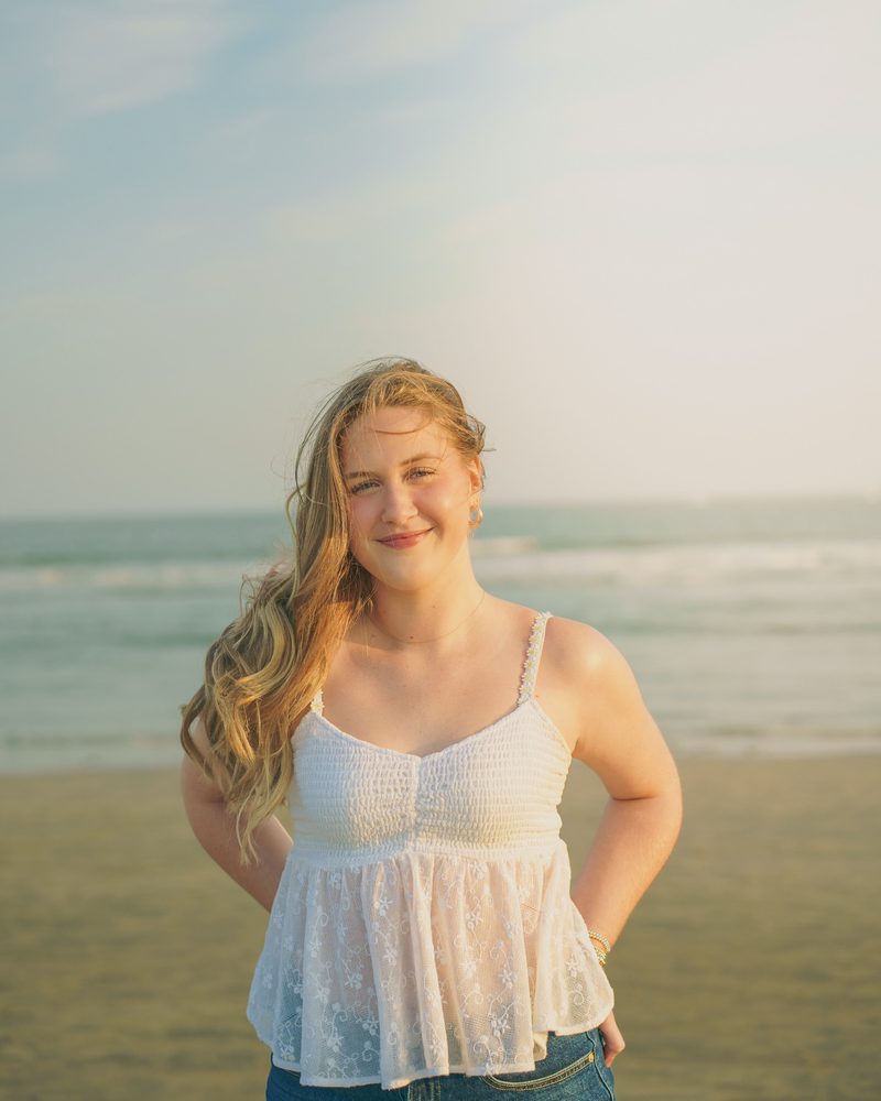 Confident standing beach portrait with ocean in the background
